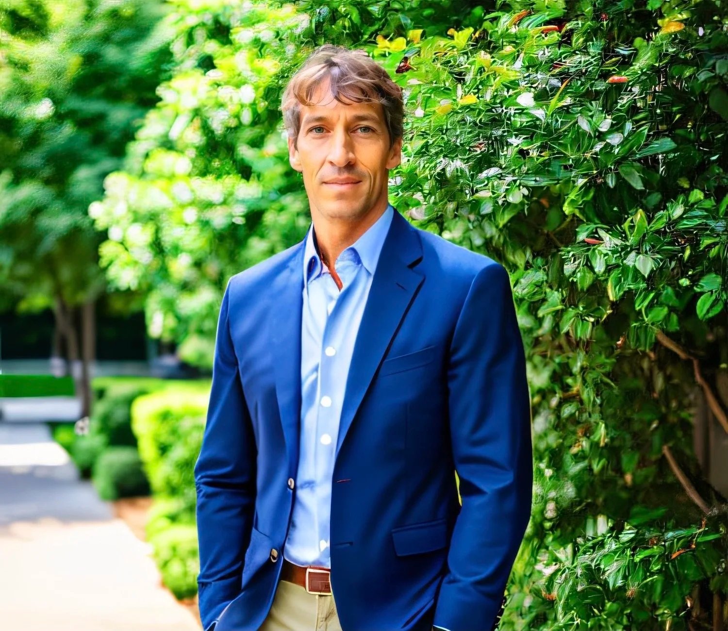 Andre Boudreaux headshot at a park in blue blazer