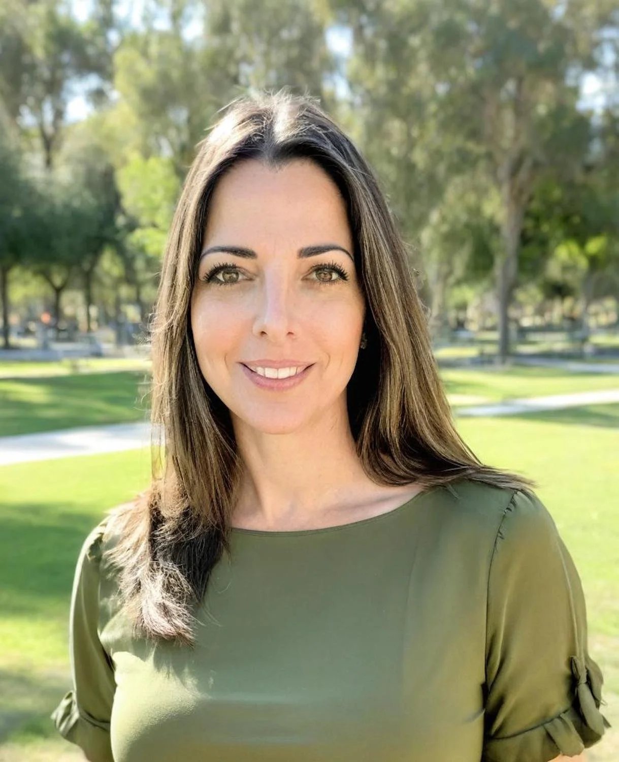 Melissa Shaw headshot at a park in olive green blouse